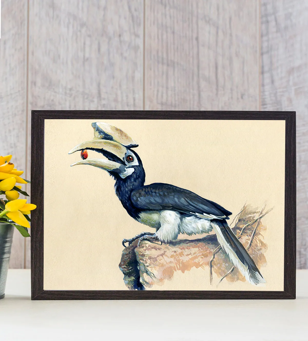 painting of a striking hornbill perched on a rock